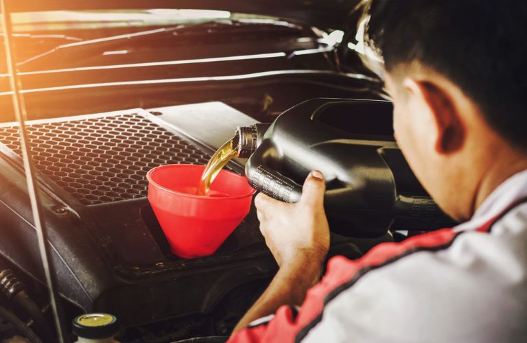 Service professional changing a vehicle's oil